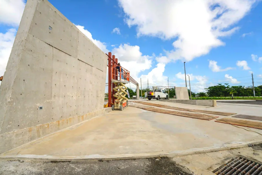 A large concrete wall is being built on a construction site by DEV Builders