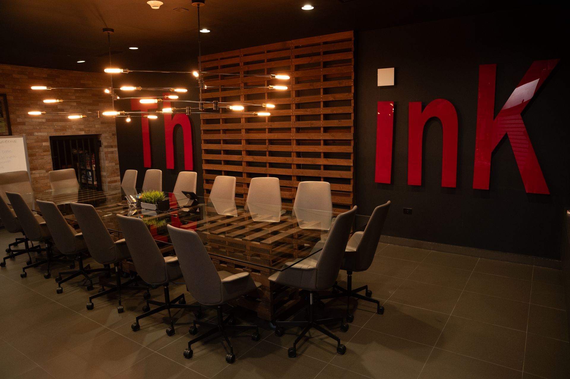 A modern conference room with a large table, chairs, and 