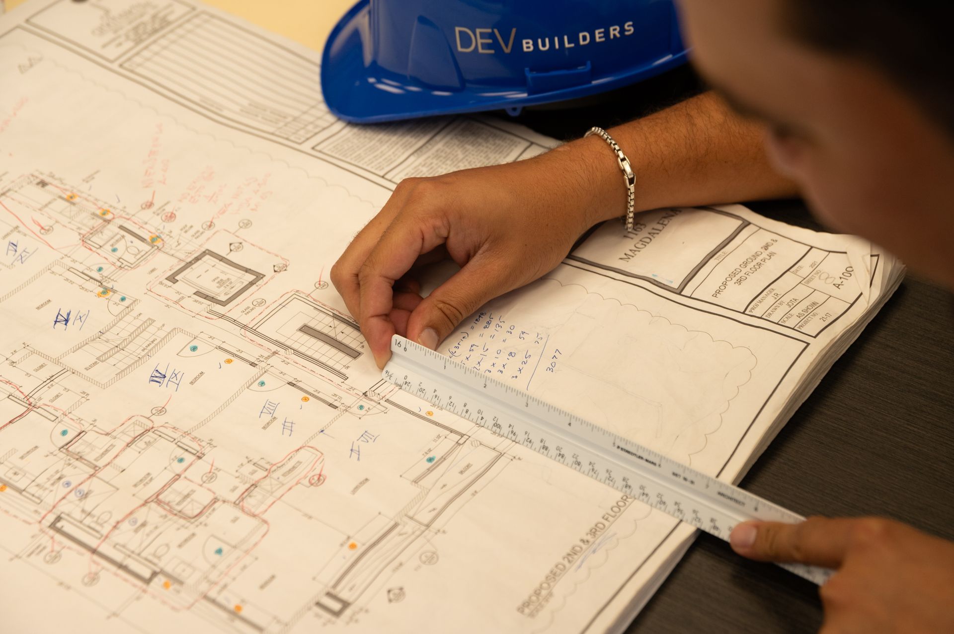 An engineer at DEV Builder is reading a blueprint