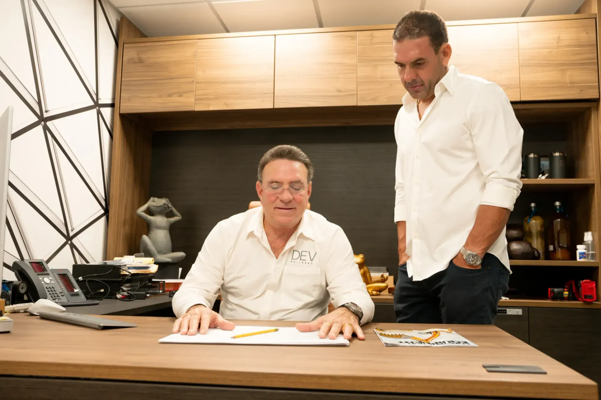 Founder of DEV Builders, Ricardo De Varona, and son talking aboout a construction projects in Puerto Rico