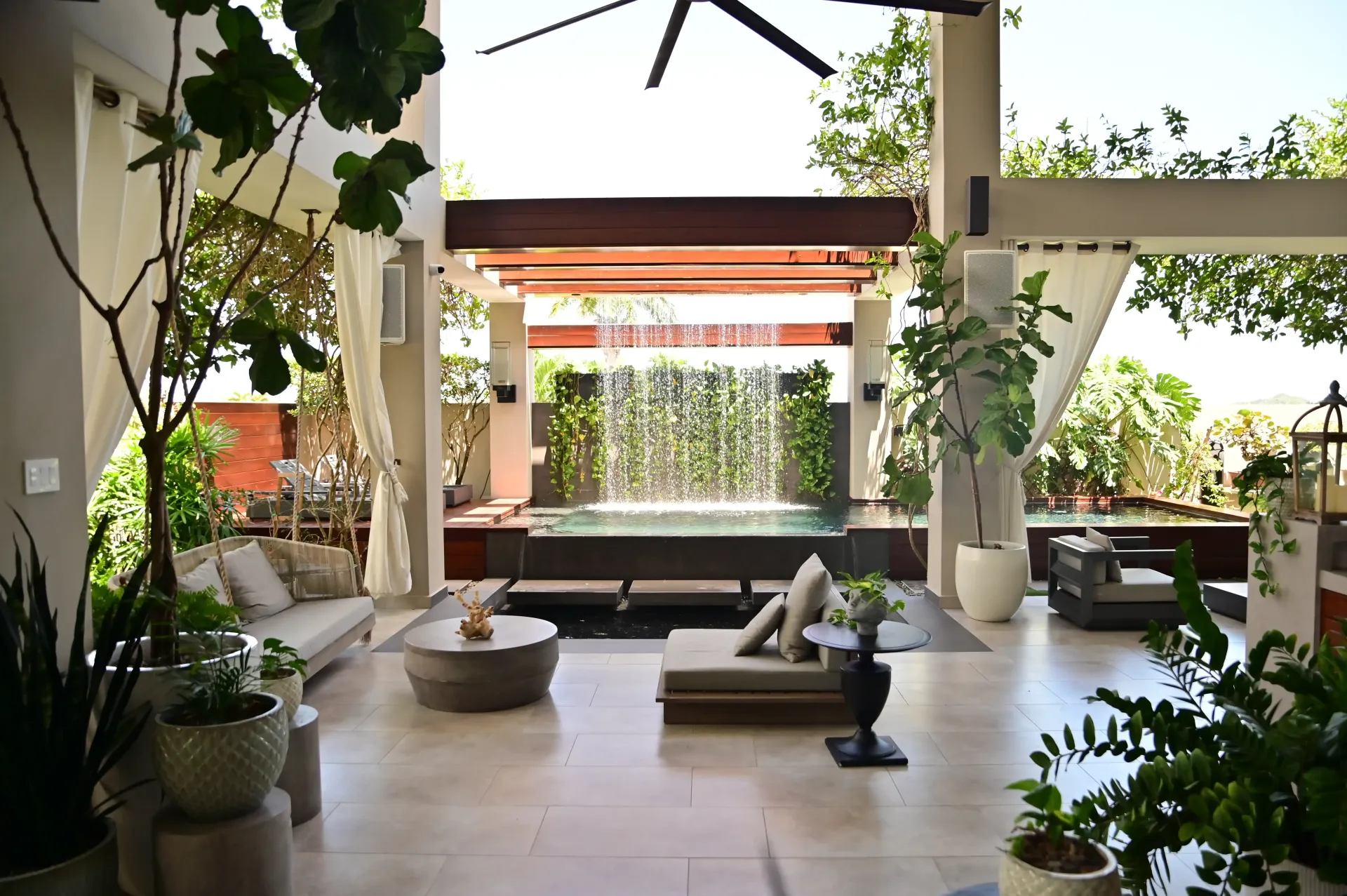 A living room with a waterfall in the background built by DEV Builders
