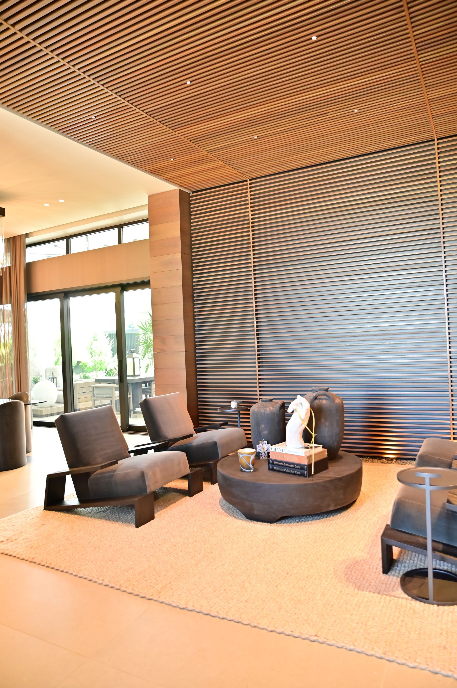 A living room with a lot of furniture and a large window built by DEV Builders