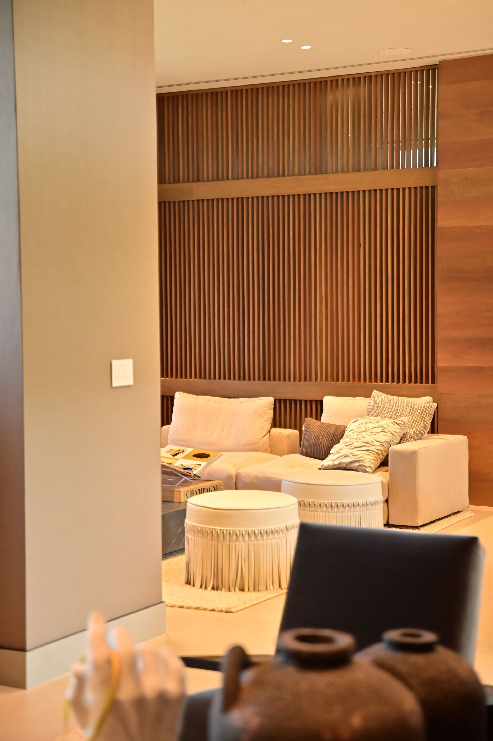 A living room with a couch , ottoman , table and chairs designed and built by DEV Builders