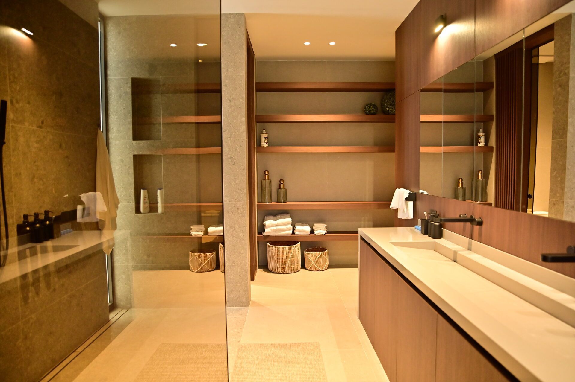 Freshly poured concrete foundation of a building under construction by DEV Builders, with visible rebar reinforcing the perimeter.