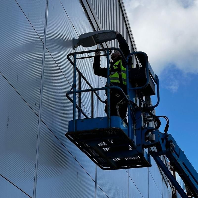 A DEV Builder worker glazing on a building.