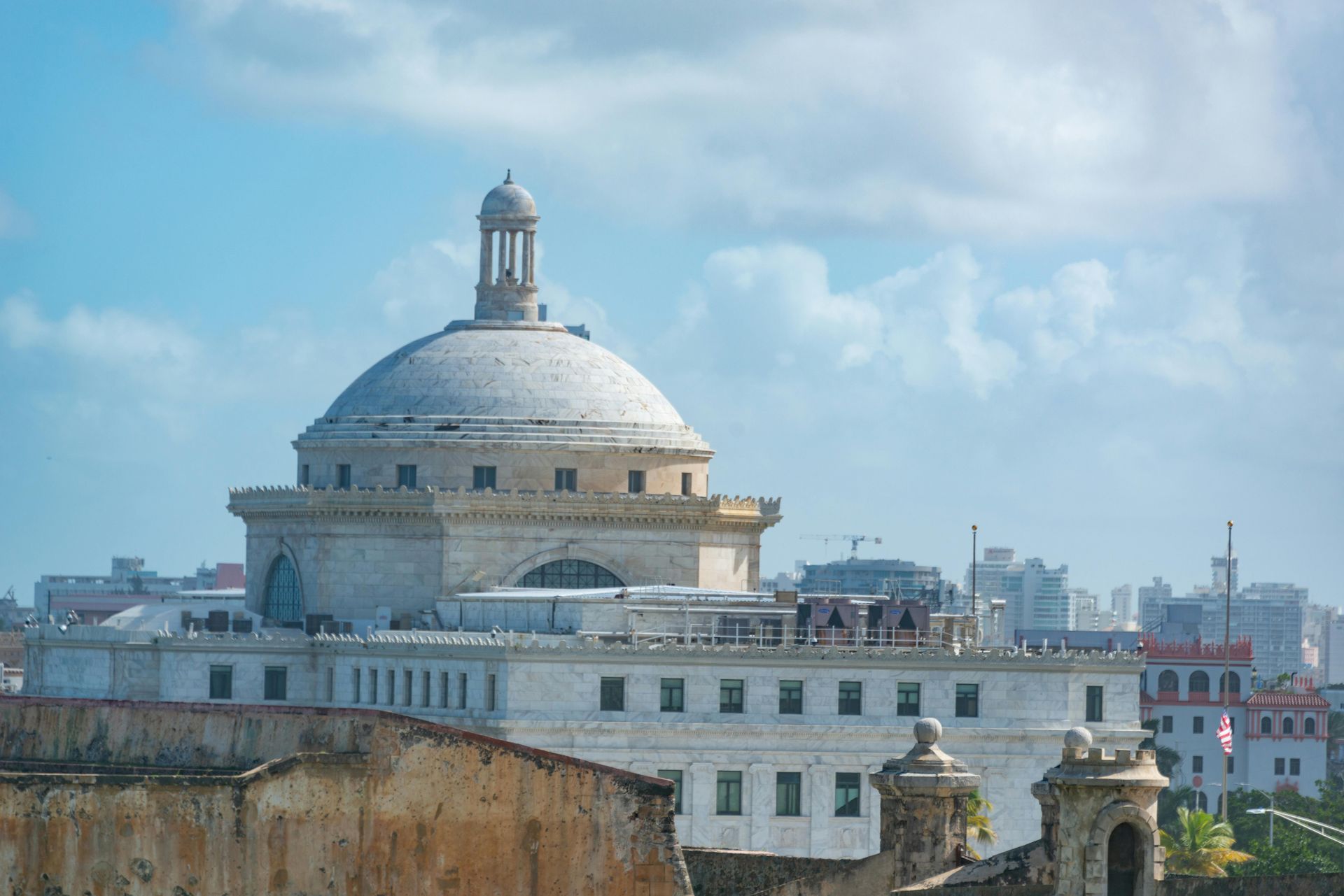Large white domed building in Havana, Cuba, under a bright blue sky.