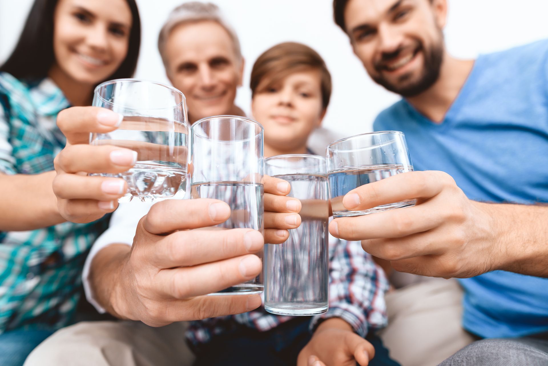 A family is toasting with glasses of water.