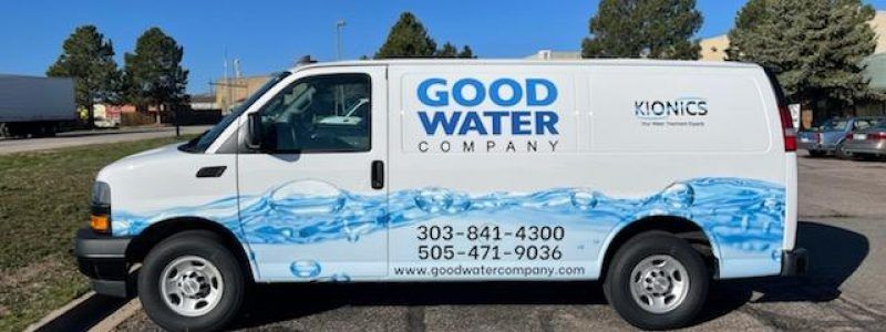 A good water company van is parked in a parking lot.