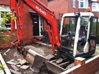 mini digger taking up front patio