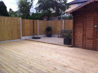 new fencing and patio with wooden shed