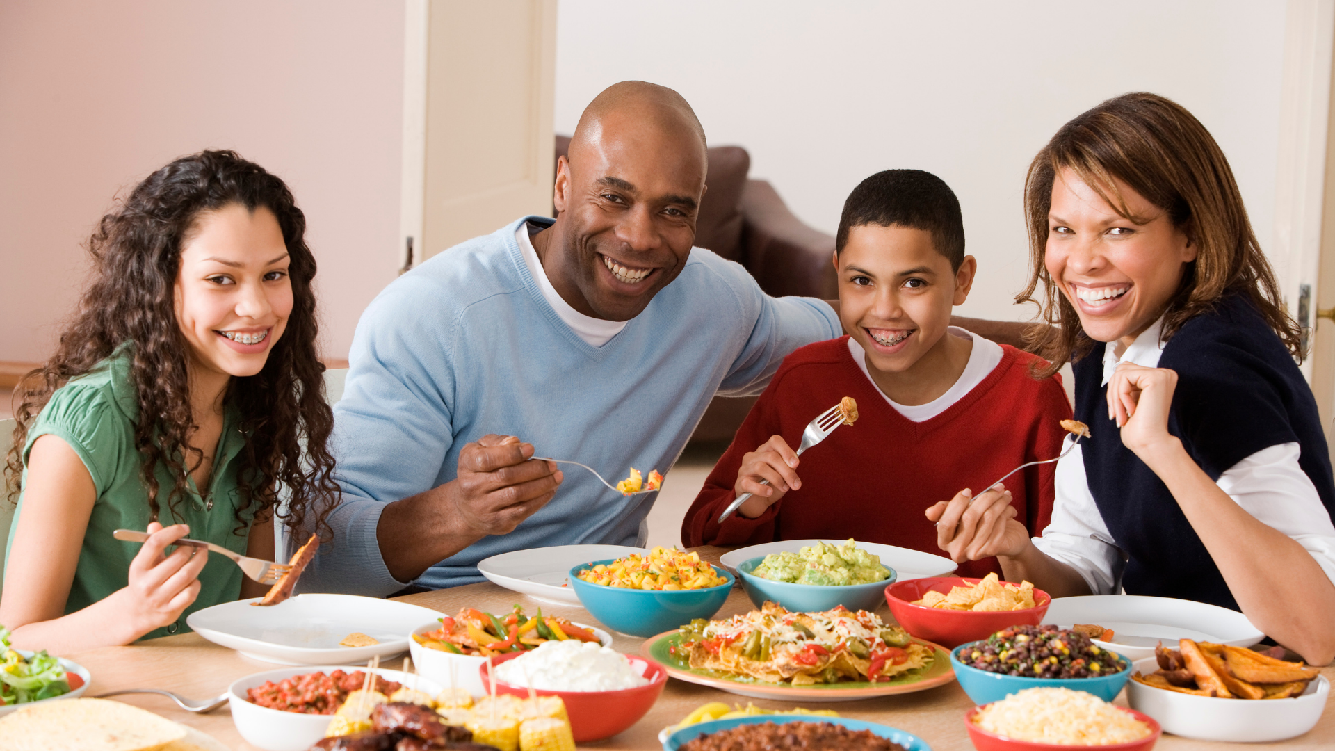 Track macros when eating out. Family enjoying a restaurant meal 