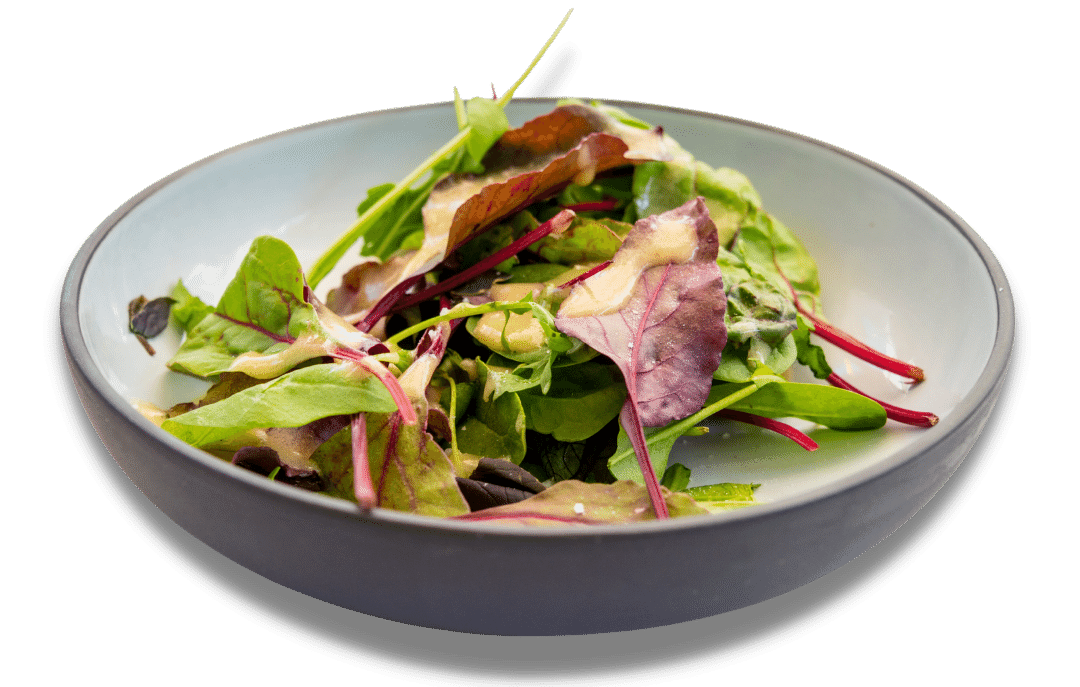 A salad in a bowl on a white background.