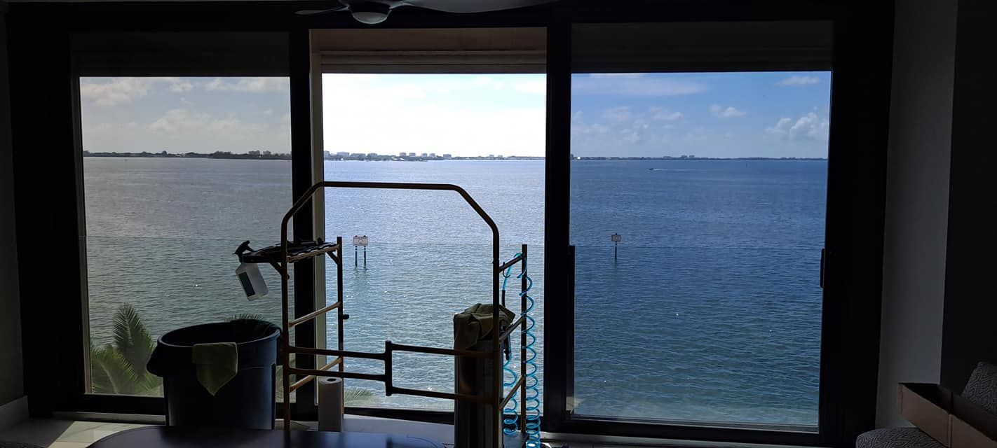 A person is applying tinted glass to a car window.