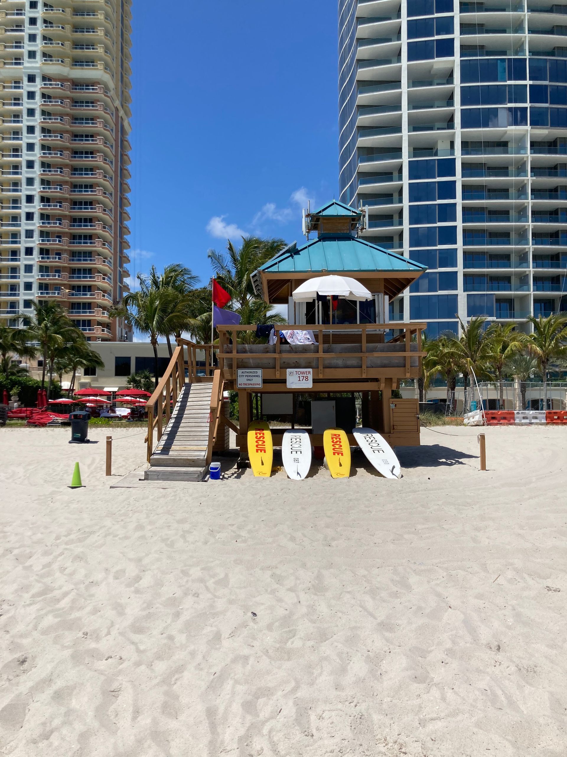 A living room with a couch , chairs , ottoman and a mirror