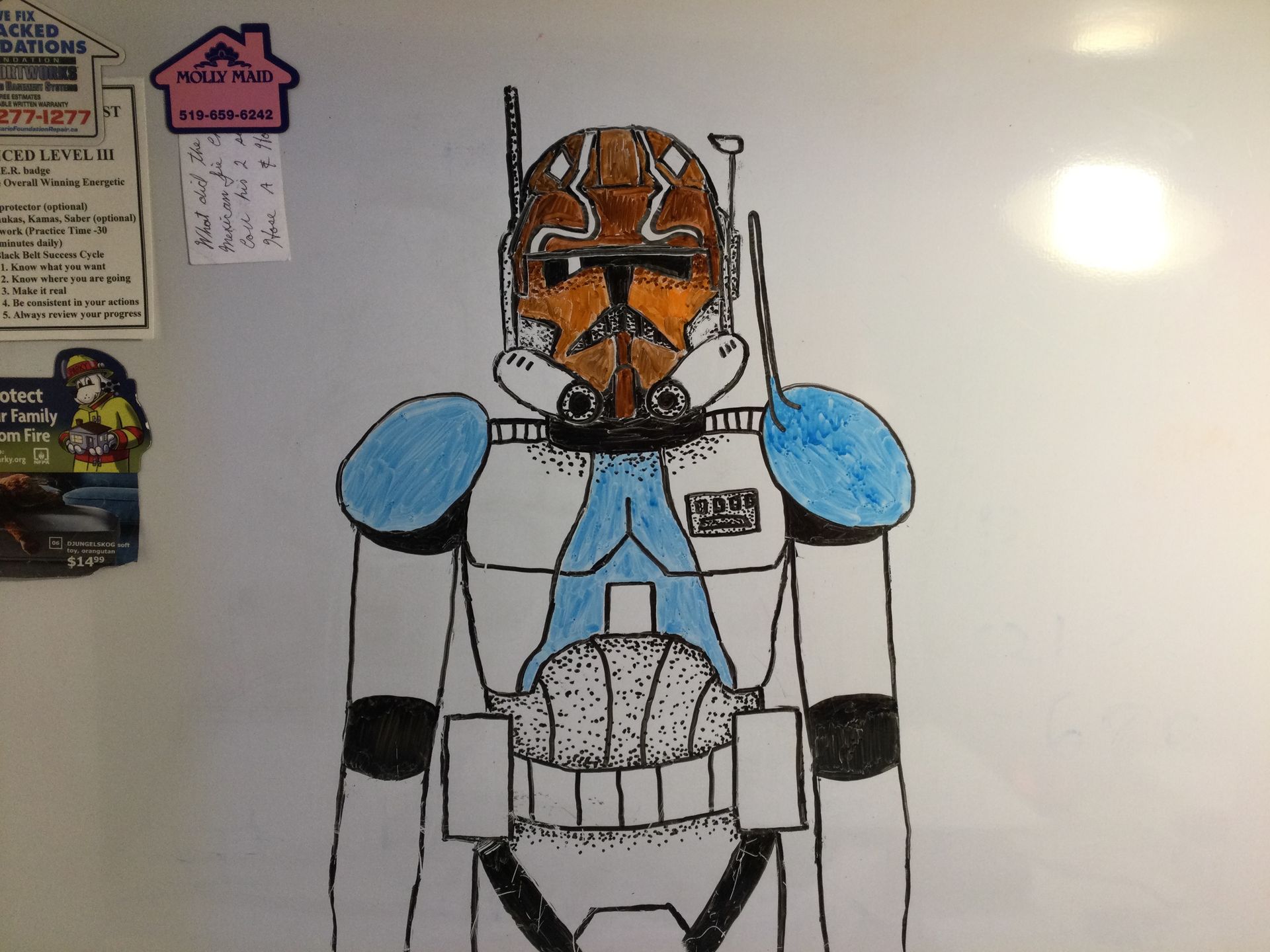 Clone Commander Cody in armor, orange and blue details on white background.