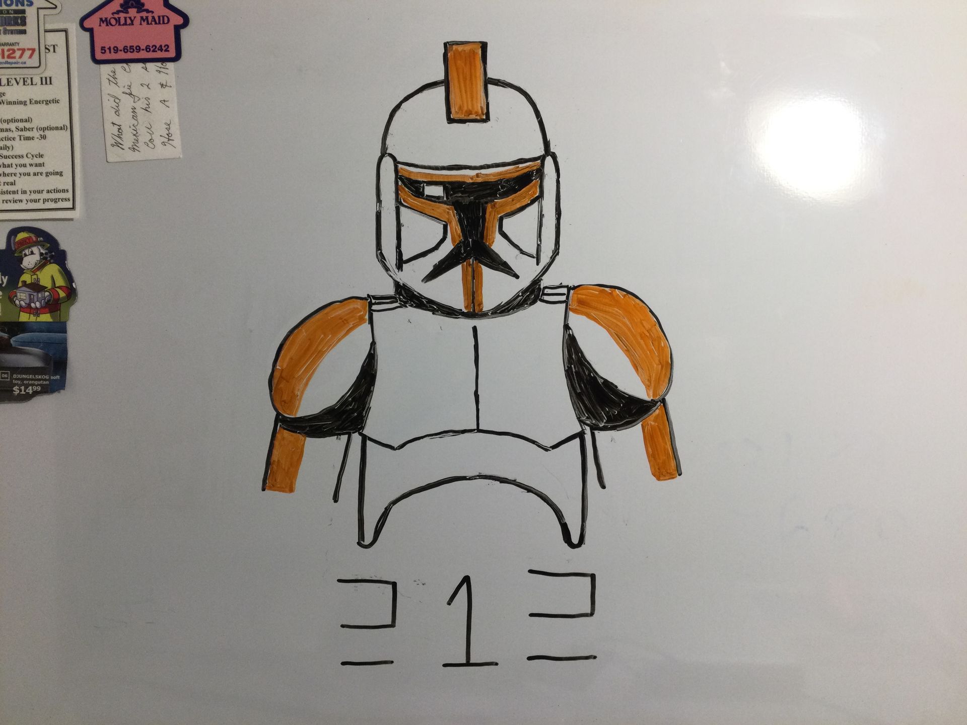Drawing of Star Wars Clone Trooper Commander Cody, orange and white armor, on a whiteboard with 