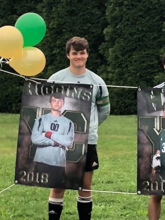 Two soccer players holding a banner that says saturdays