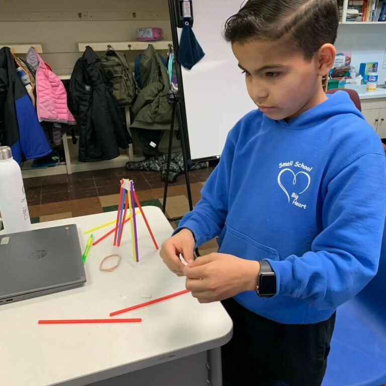 A boy wearing a blue hoodie with a heart on it