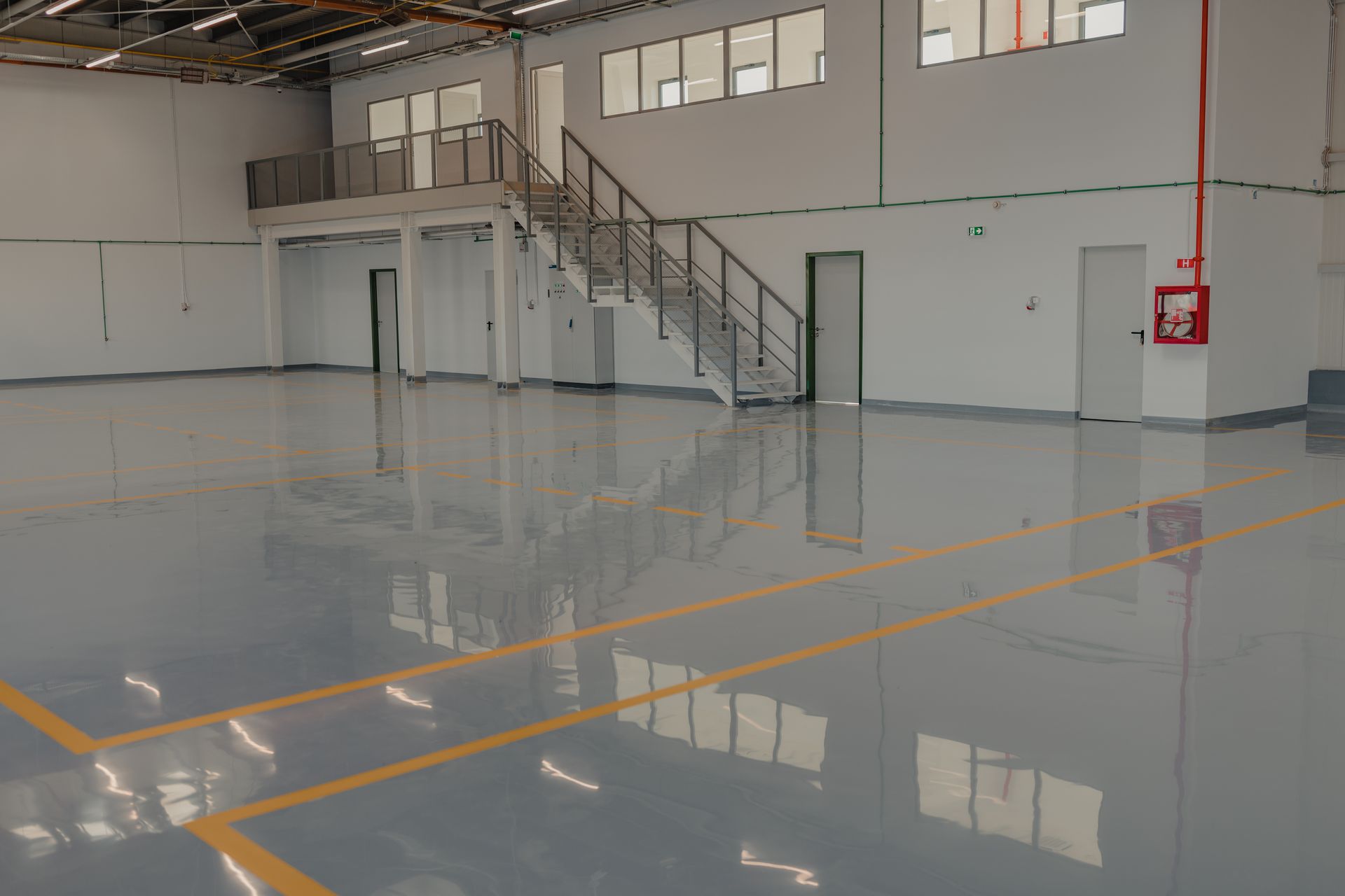 Epoxy flooring with colorful signage in an empty warehouse.