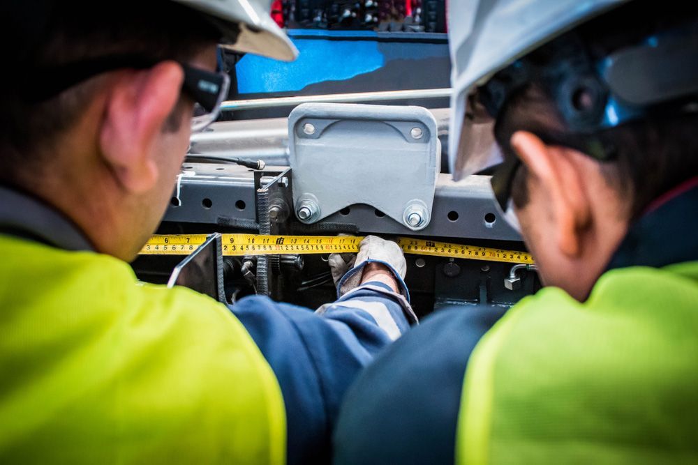 Men Repairing Hydraulic System — Rowdraulics NQ Pty Ltd in Mount Louisa, QLD