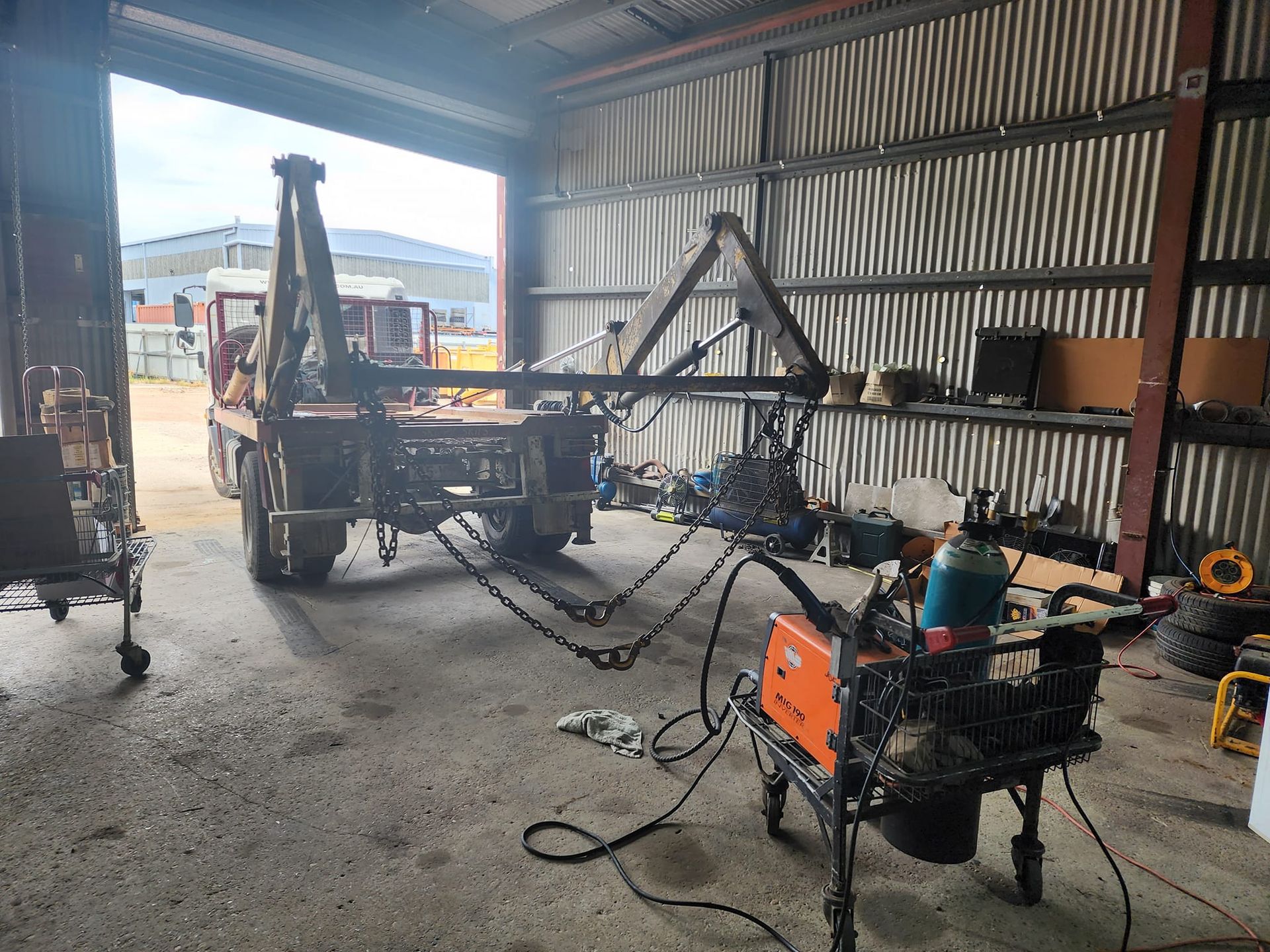 Truck In A Garage With A Welding Machine To Repair Hydraulics — Rowdraulics NQ Pty Ltd in Mount Isa, QLD