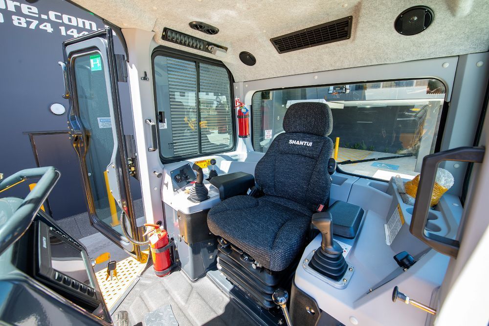 The Inside of a Bulldozer With a Black Seat and a Fire Extinguisher — Rowdraulics NQ Pty Ltd in Mount Louisa, QLD
