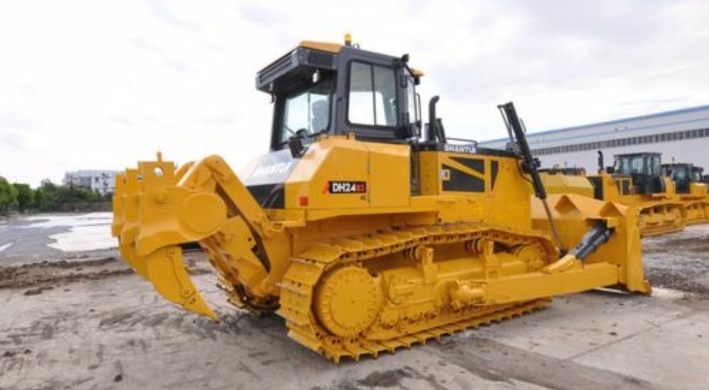 A Yellow Bulldozer is Parked in Front of a Building — Rowdraulics NQ Pty Ltd in Mount Louisa, QLD