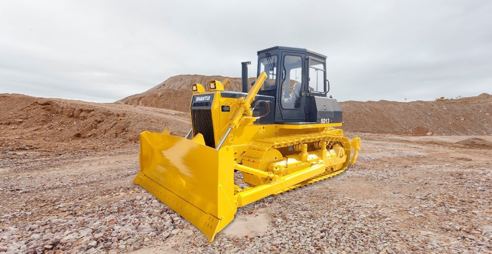 A Yellow Bulldozer is Parked in a Dirt Field — Rowdraulics NQ Pty Ltd in Mount Louisa, QLD