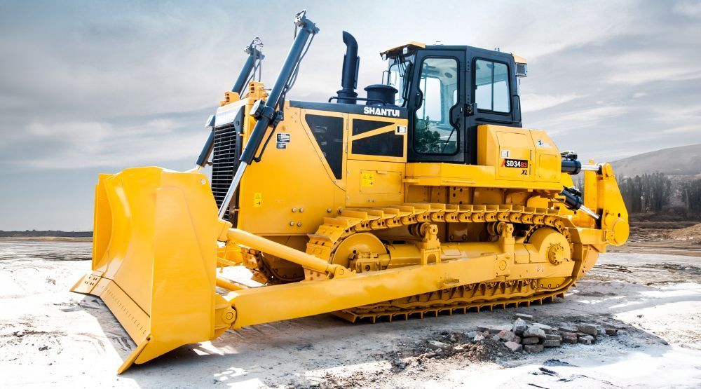 A Yellow Bulldozer is Parked in a Dirt Field — Rowdraulics NQ Pty Ltd in Mount Louisa, QLD
