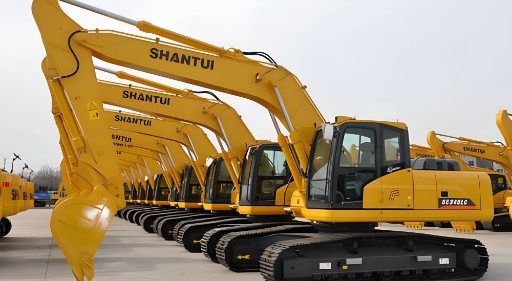 A Row of Yellow Shantui Excavators Are Parked in a Parking Lot — Rowdraulics NQ Pty Ltd in Mount Louisa, QLD