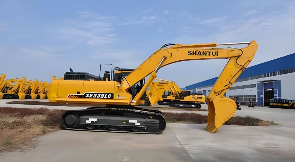A Yellow Excavator is Parked in Front of a Building — Rowdraulics NQ Pty Ltd in Mount Louisa, QLD