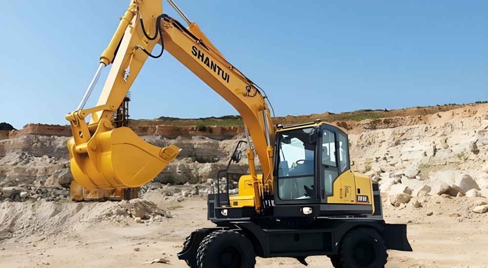 A Yellow Shantui Excavator is Working in a Dirt Field — Rowdraulics NQ Pty Ltd in Mount Louisa, QLD