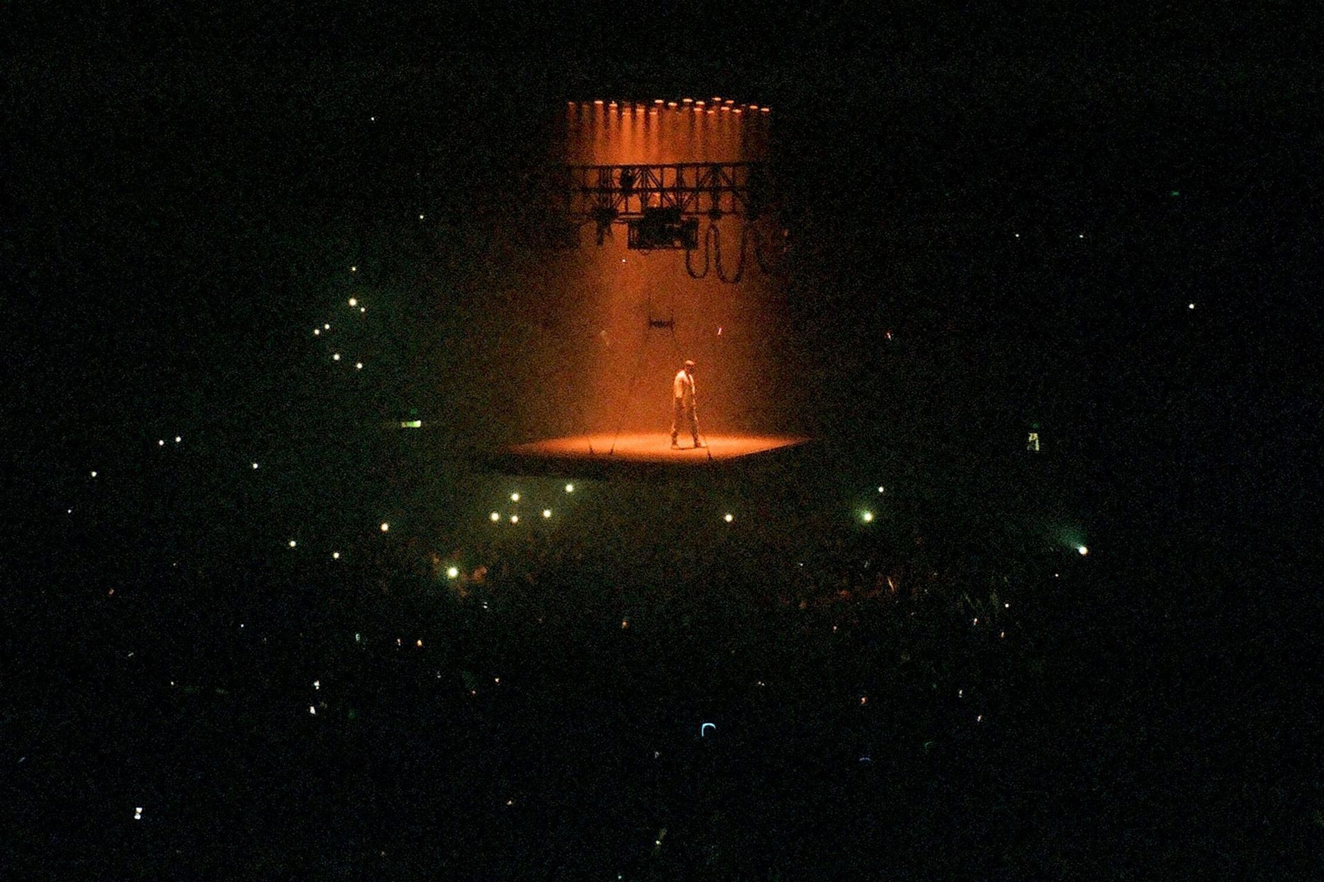 A man is standing on a stage in front of a crowd