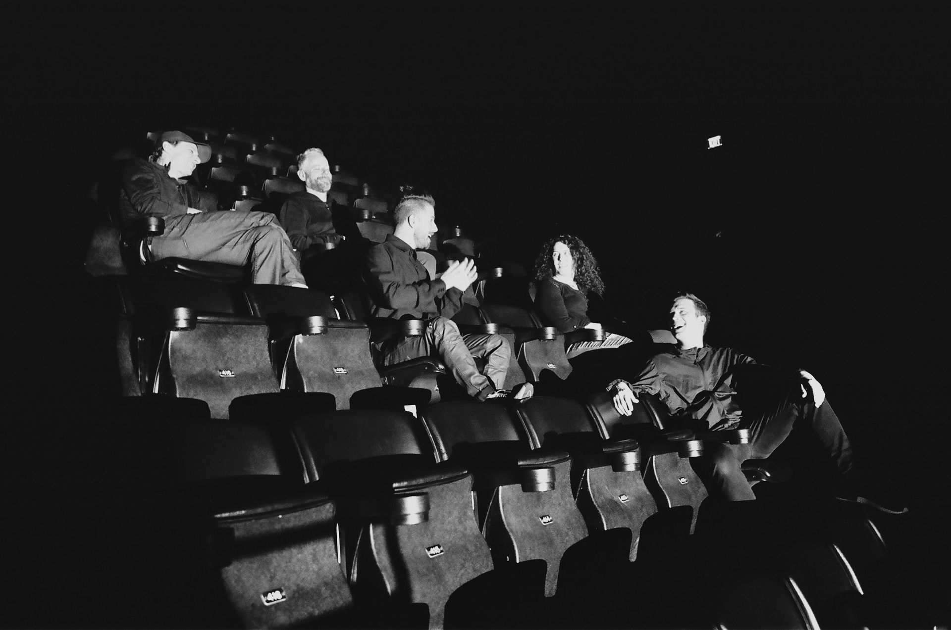A group of people are sitting in a theater watching a movie