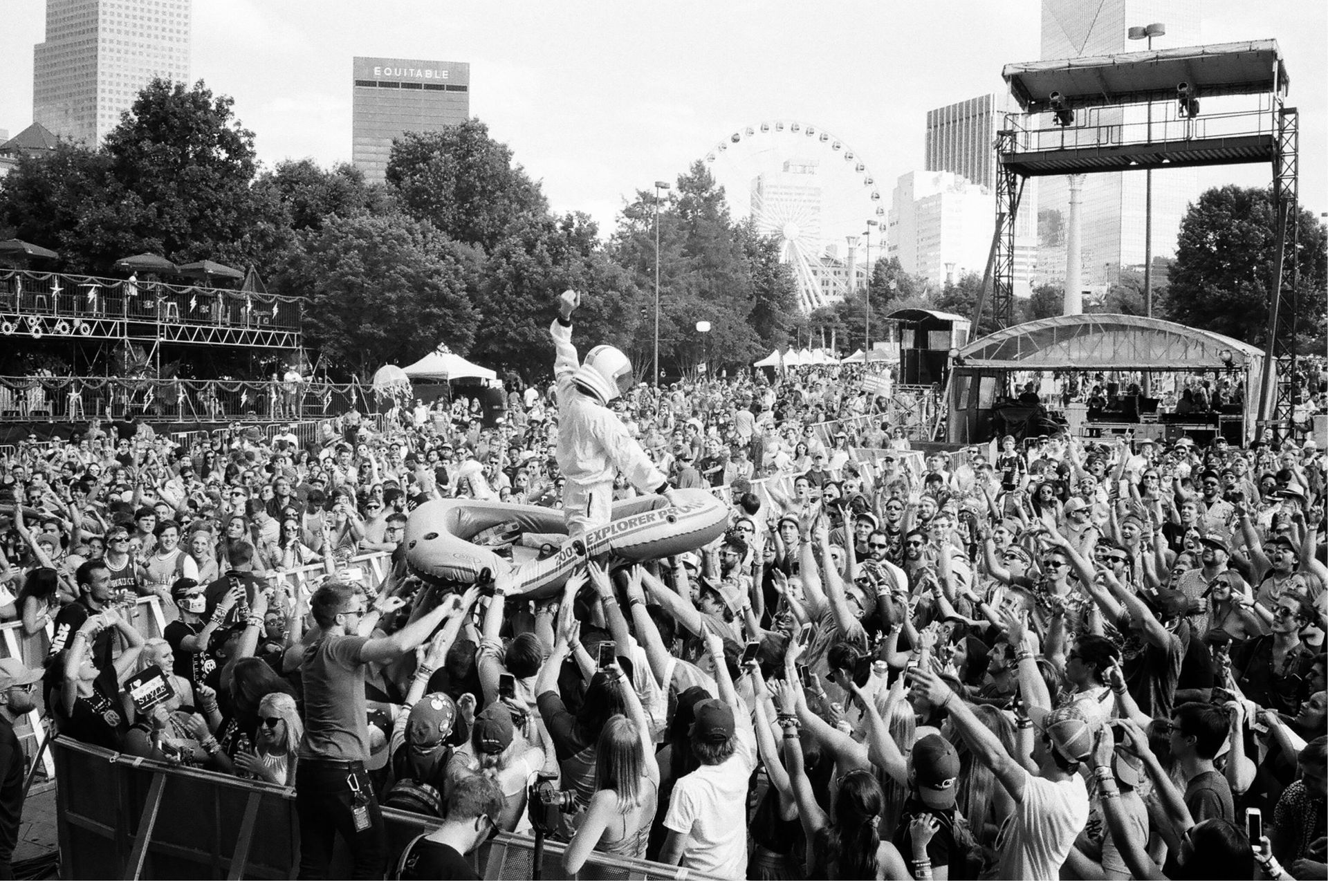 A black and white photo of a crowd of people at a concert.