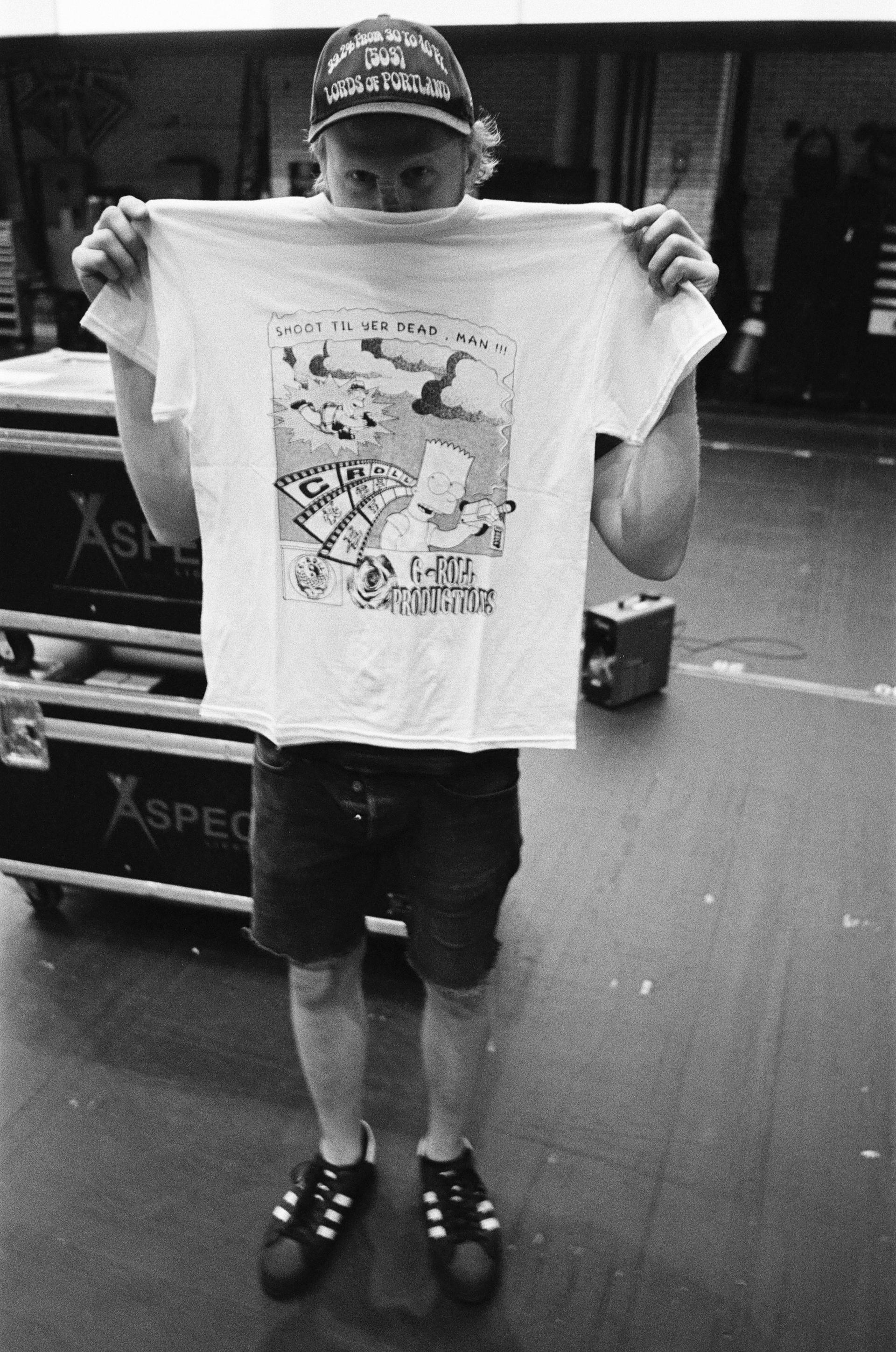 An artist holding a t-shirt created by C-Roll productions