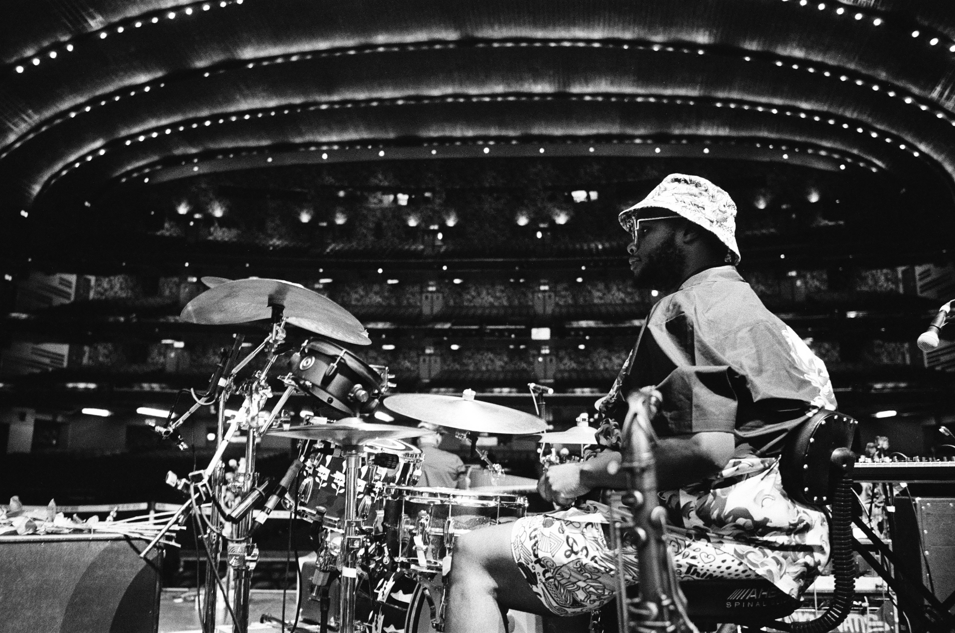 A black and white photo of a man playing drums