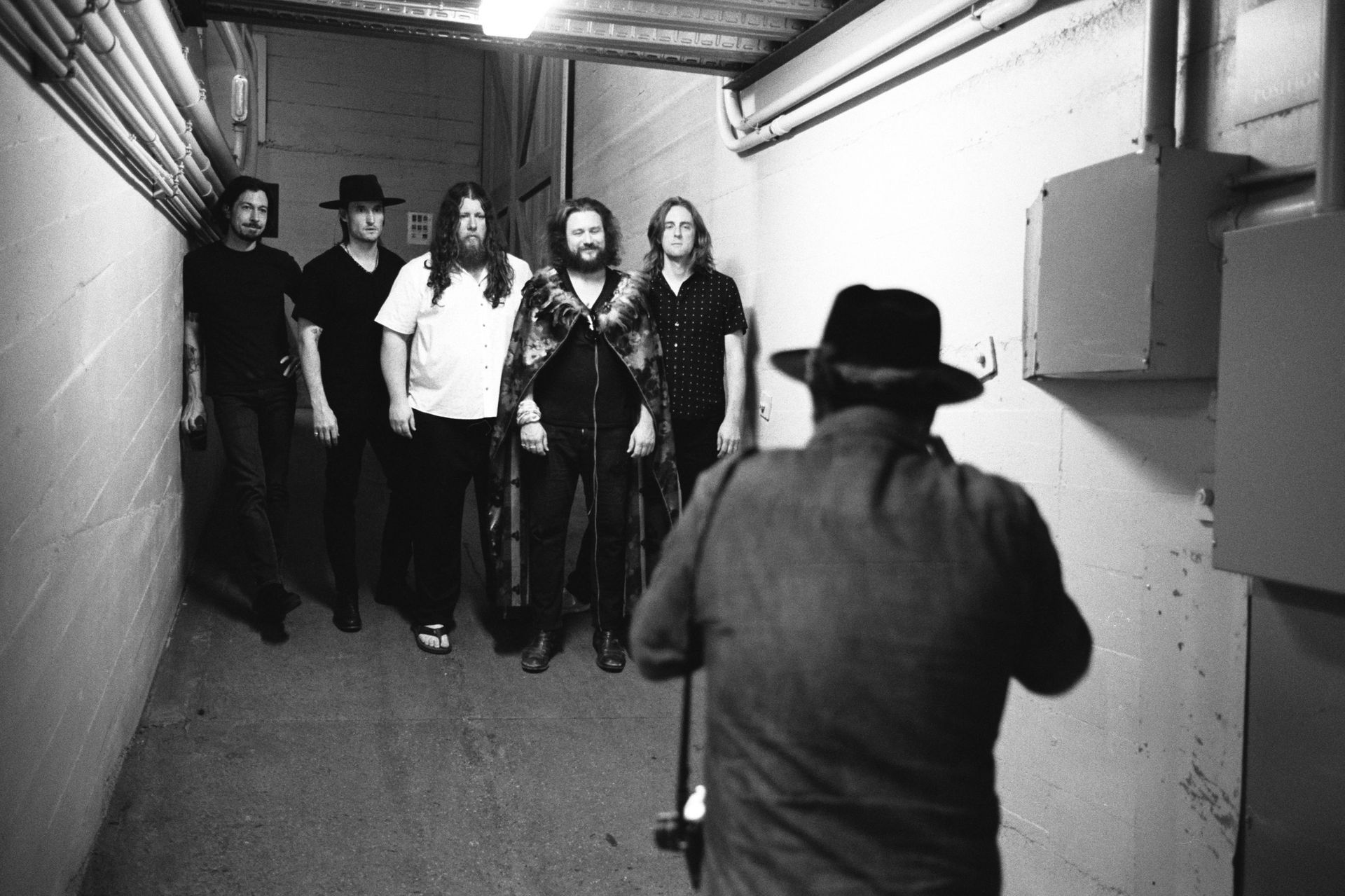 Photo of a band backstage getting ready to perform a concert