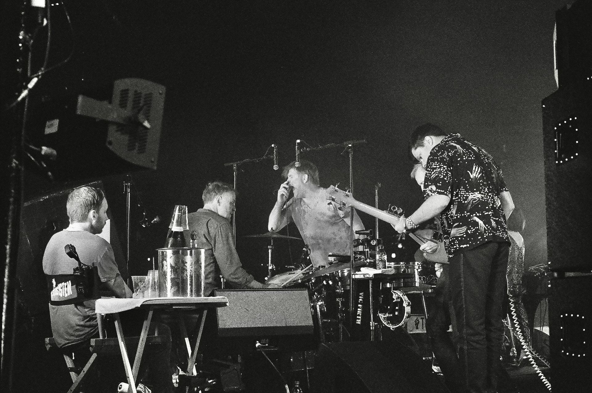 A black and white photo of a band on stage