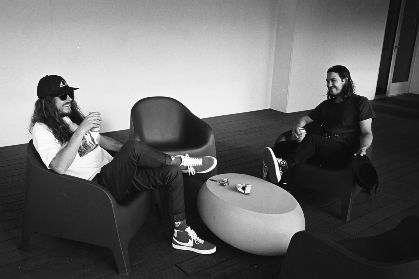 A black and white photo of two men sitting in chairs