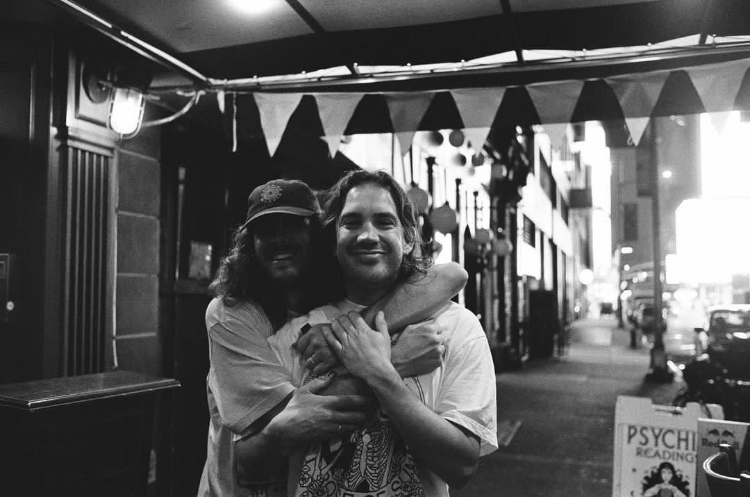 Founders of C-Roll Productions, C.J. & Rahm, hugging together with smiles