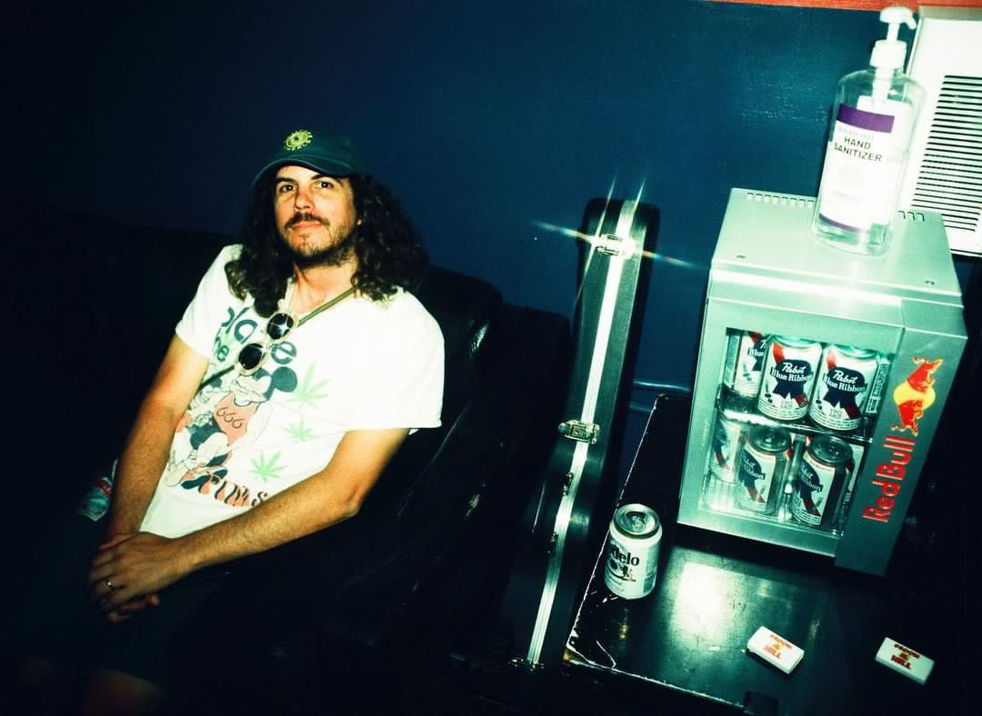 C.J. of C-Roll Productions smiling backstage at a concert venue