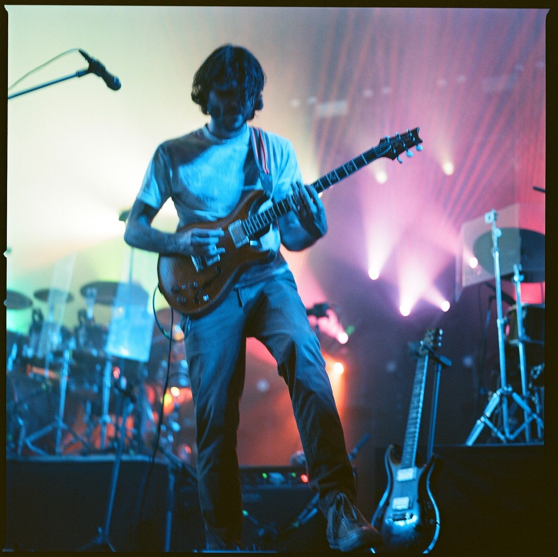 A man is playing a guitar on a stage