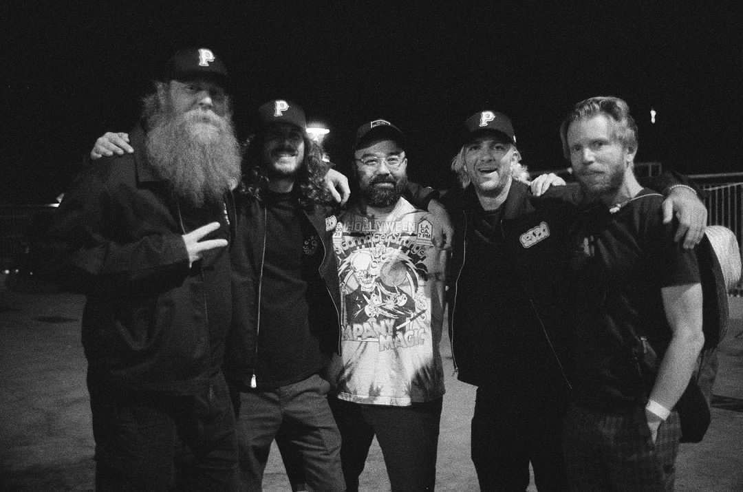 A group of men are posing for a picture together in a black and white photo.