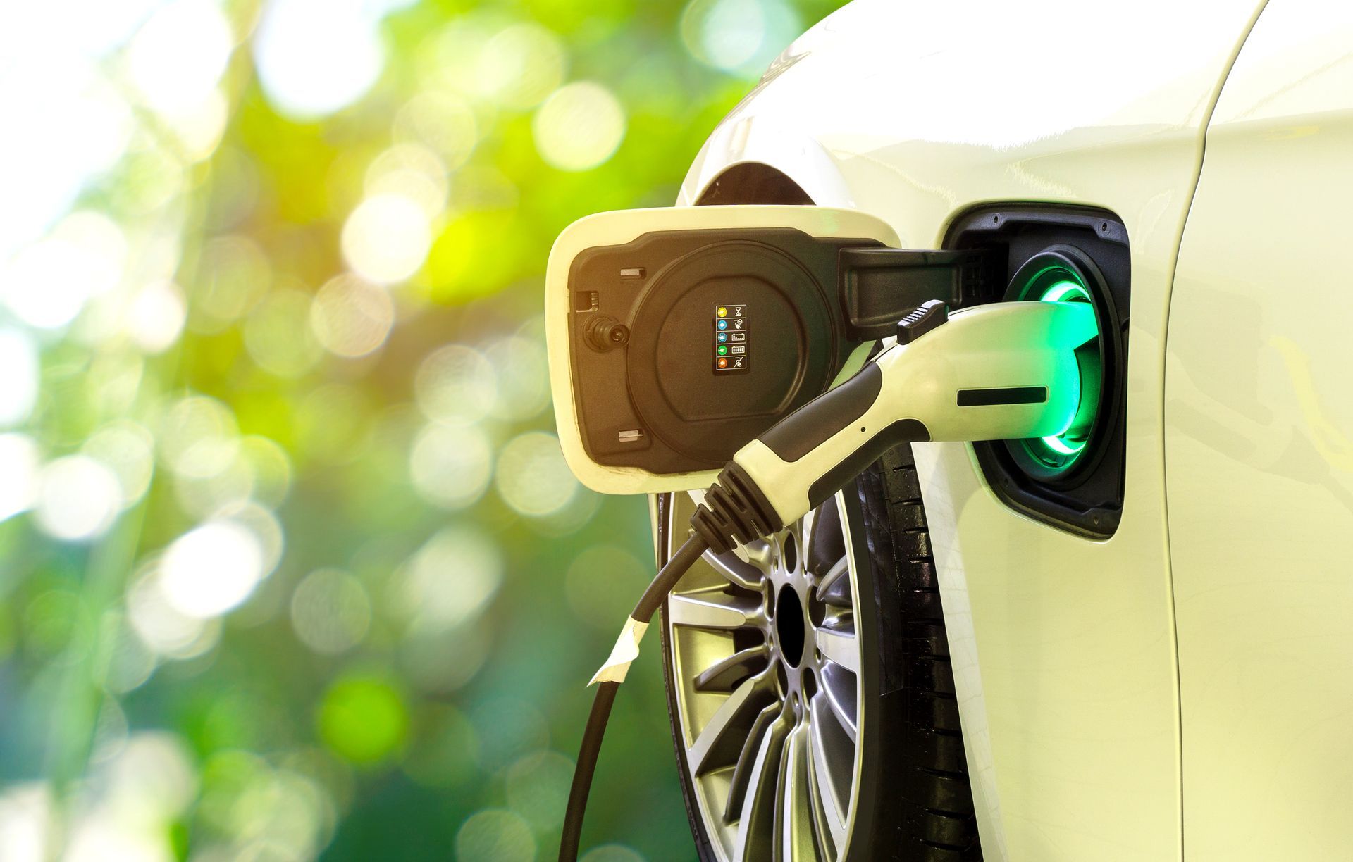 An electric car is being charged at a charging station.