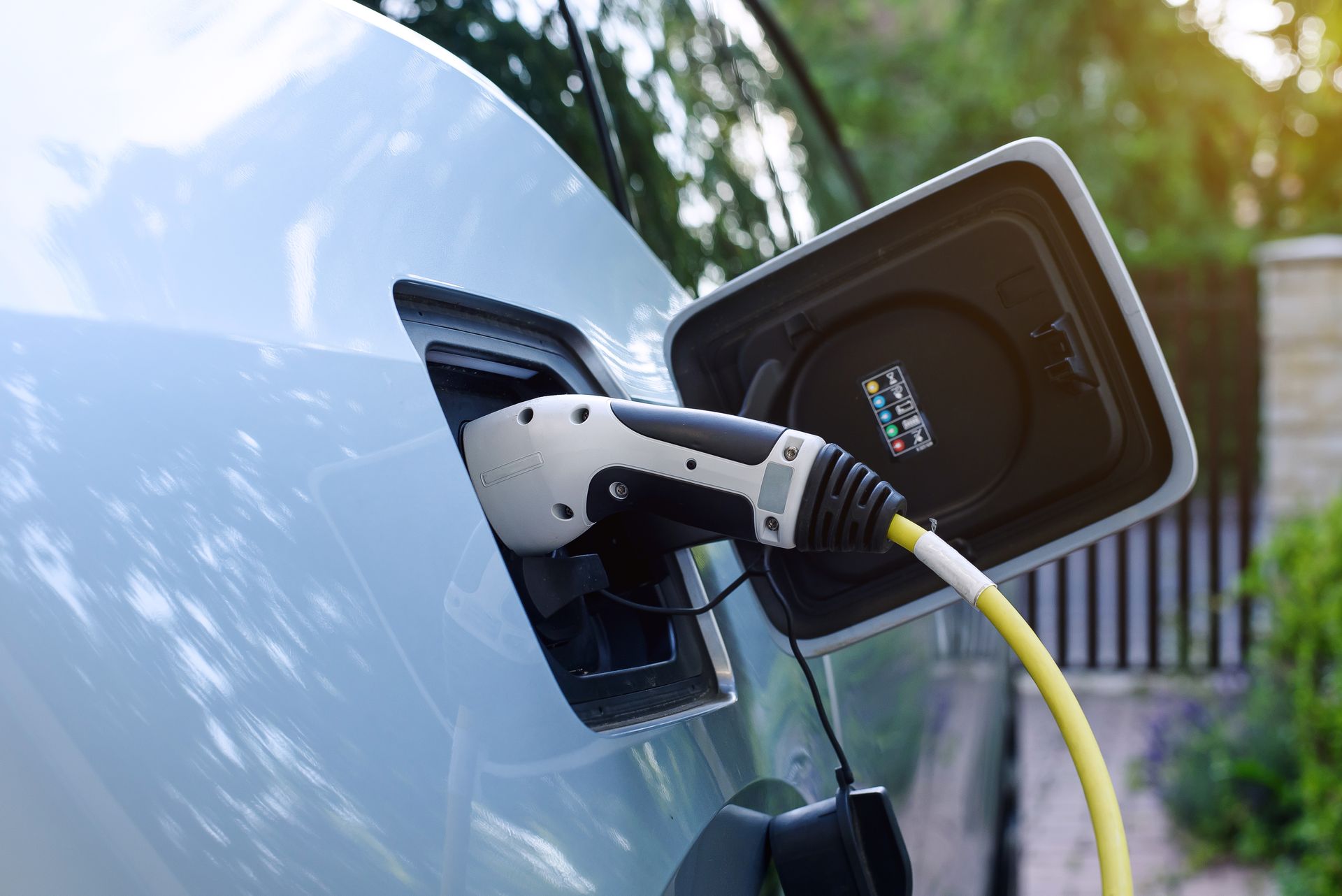 An electric car is being charged at a charging station.