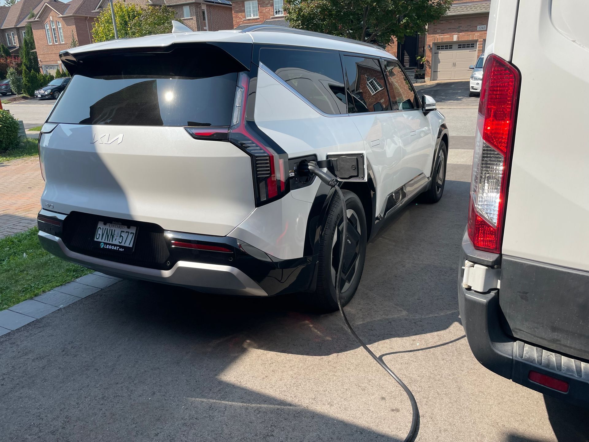 An electric car is being charged at a charging station.