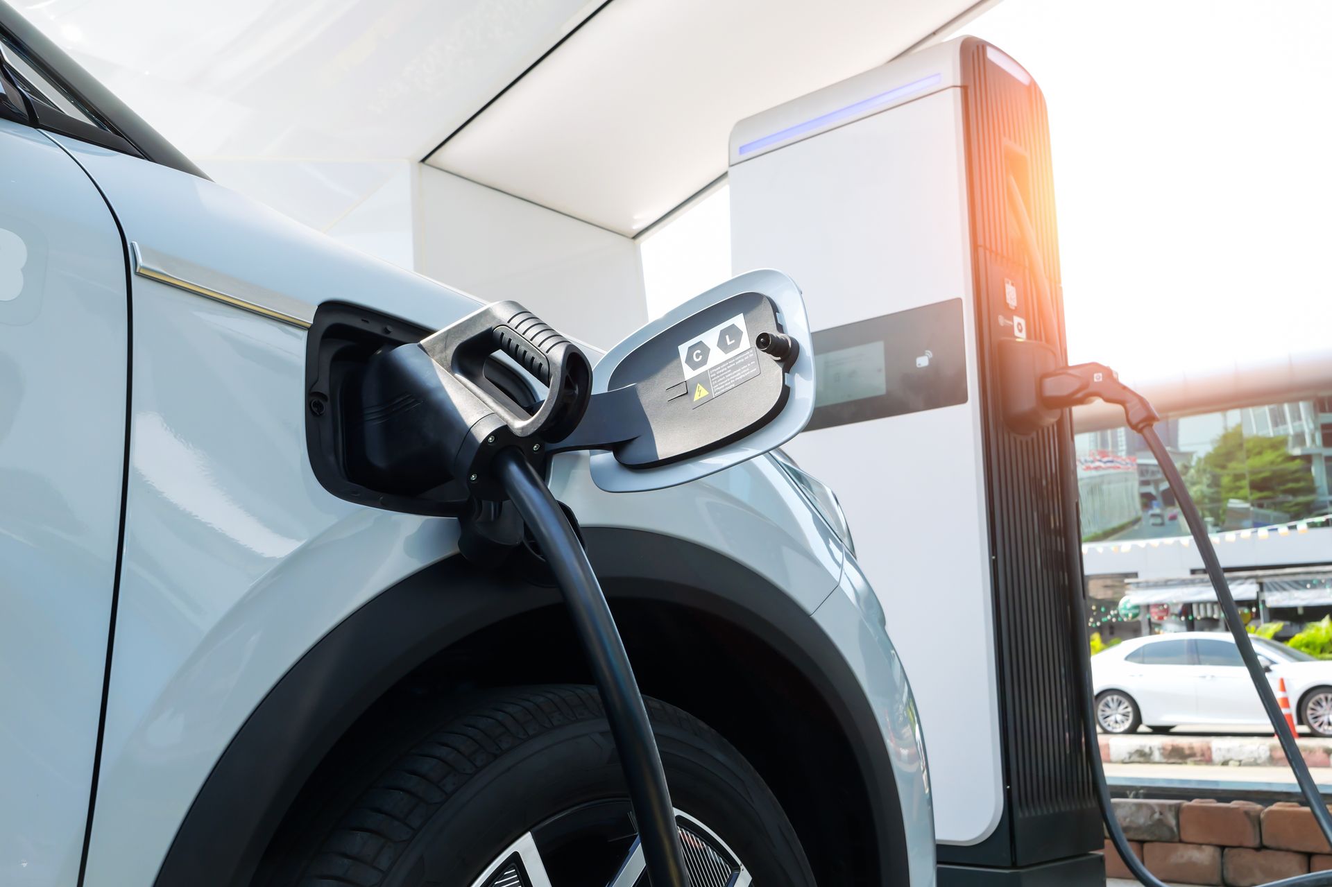 An electric car is being charged at a charging station.