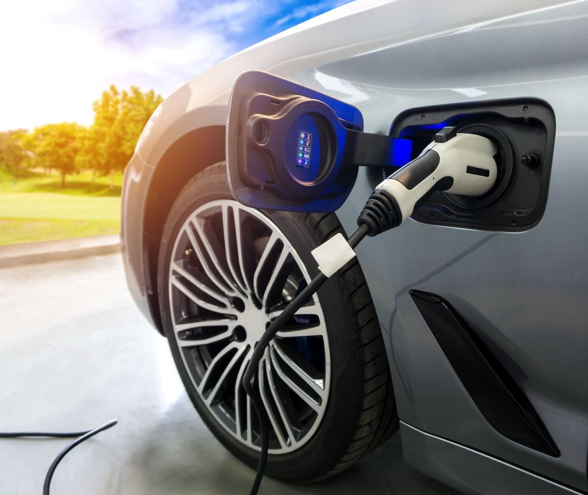 An electric car is being charged at a charging station.