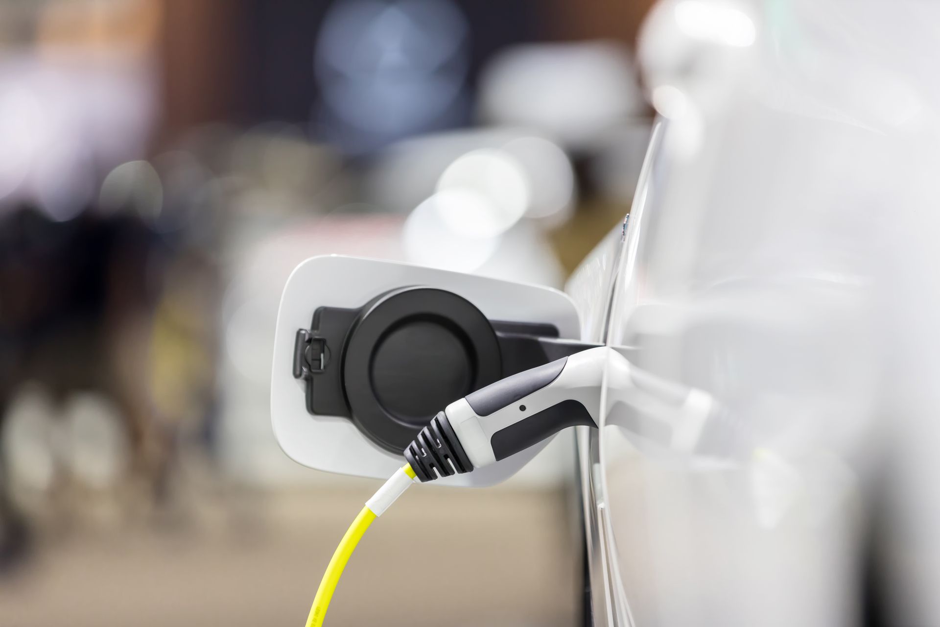 A close up of an electric car being charged.